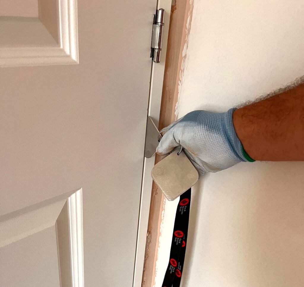 Gap gauge measuring the space between a fire door and its frame